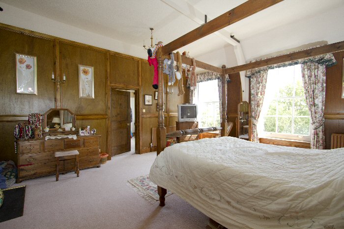 wood panelled master bedroom